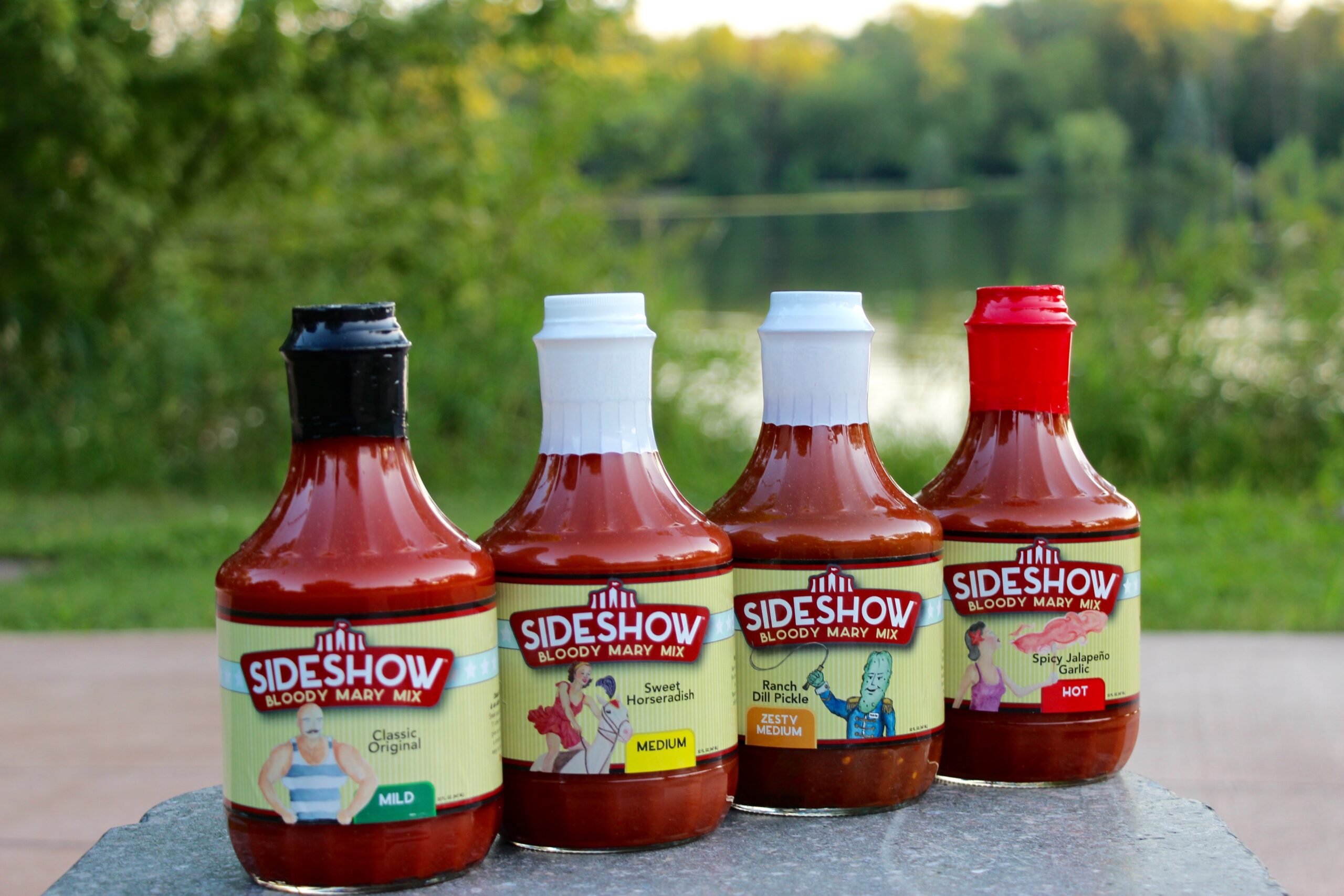 A group of bottles of ketchup sitting on top of a table.