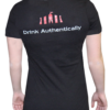 A woman wearing a black t-shirt with the words " drink authentically ".