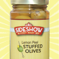 A jar of stuffed olives with lemon peel.